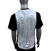 A man wearing a white vest with two metal plates on it.