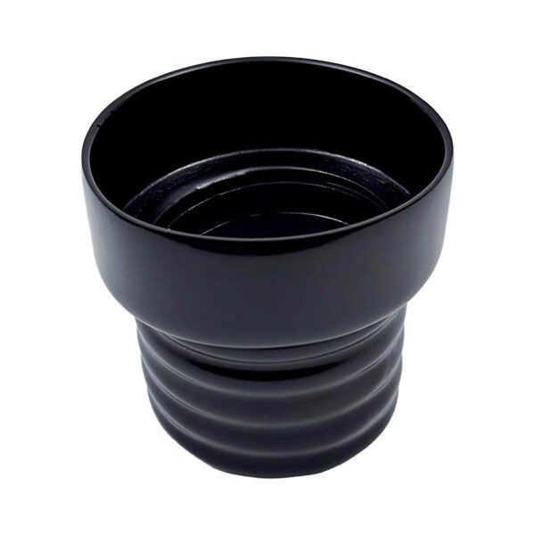 A black cup is sitting on the floor